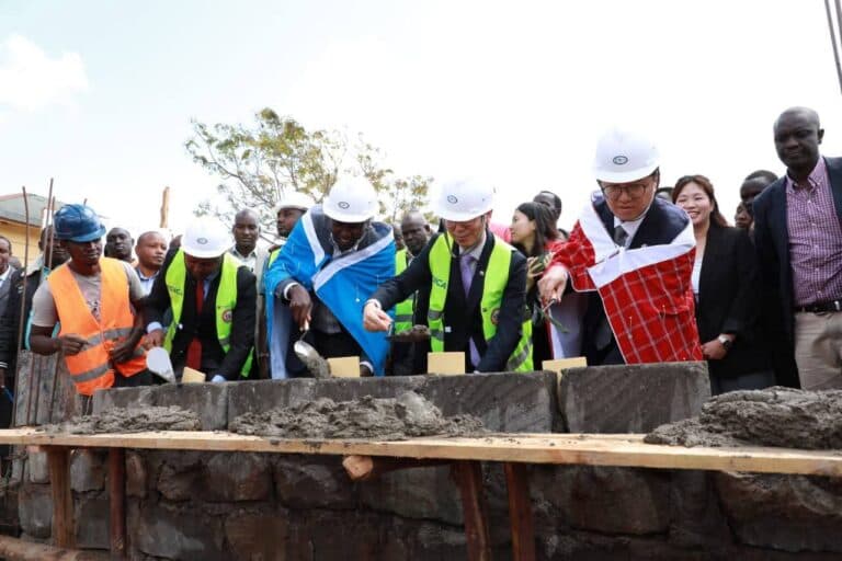 Community members and partners at a construction site for a new facility